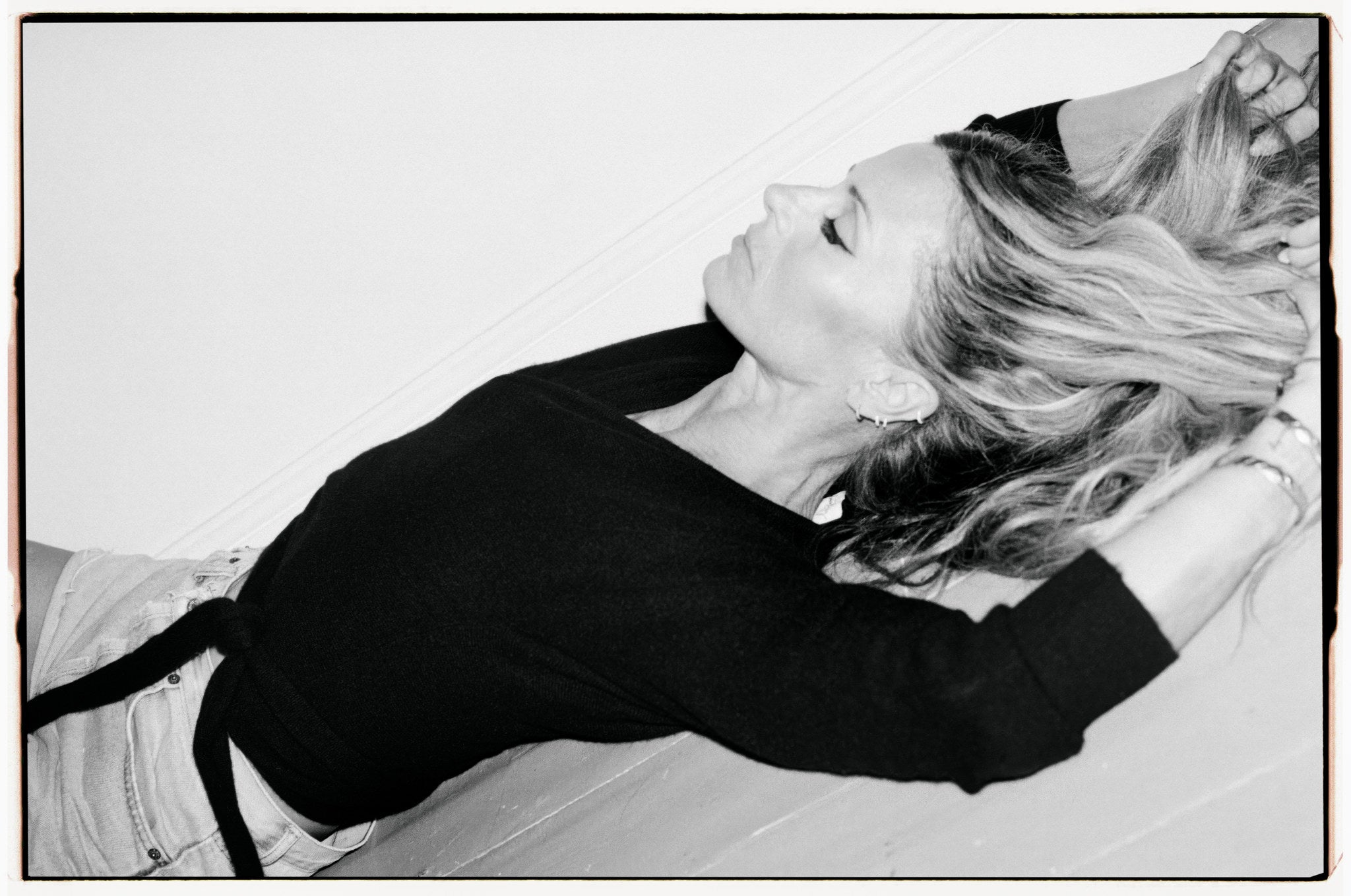 Black and white Laura Bailey campaign portrait in black knitwear
